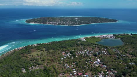 aerial view of two islands in the middle of the ocean in indonesia - gili meno and gili t at the background with it stunning turquoise water beach shore