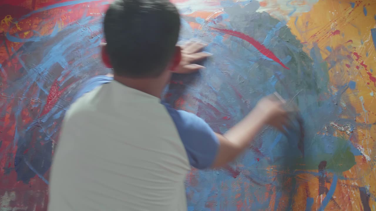 Artist working on a large abstract painting