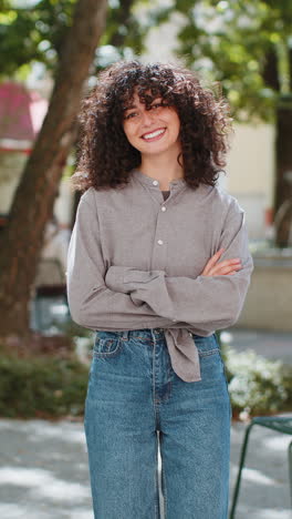 Happy-young-woman-smiling-turning-looking-at-camera-resting-good-news-feel-satisfied-on-city-street