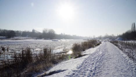 frozen river with ice floes during winter with block of flat in the background-1