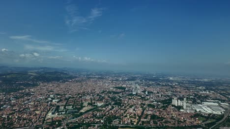 Aerial-view-of-Bologna-city,-and-the-airport-runway-at-the-back