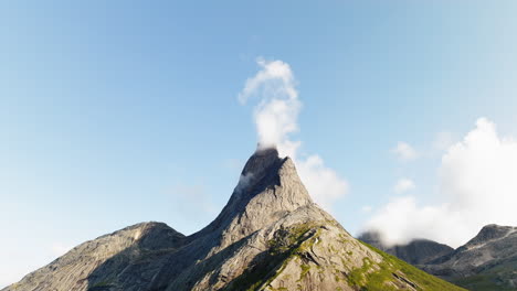 distinctlive stetinden peak against blue sky with thin cloud, nordland