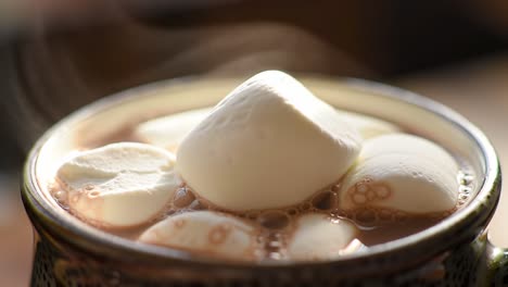 indulge in a luxurious cup of hot chocolate topped with fluffy marshmallows, perfect for cozy evenings and warming up on cold days with its steam and creamy texture