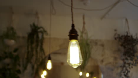 Ominous-swinging-ceiling-light-in-an-empty-restaurant