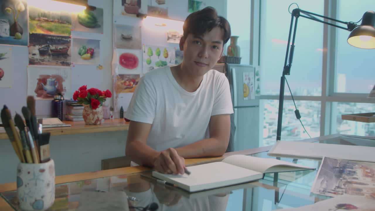 Asian Man Drawing Sketch at Workplace in Art Studio