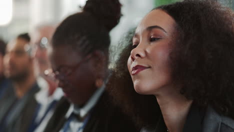 a woman listens intently during a conference or seminar.