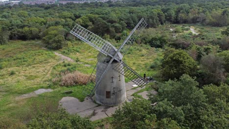 bidston hill disused rural flour mill restored traditional wooden sail windmill birkenhead aerial view dolly left