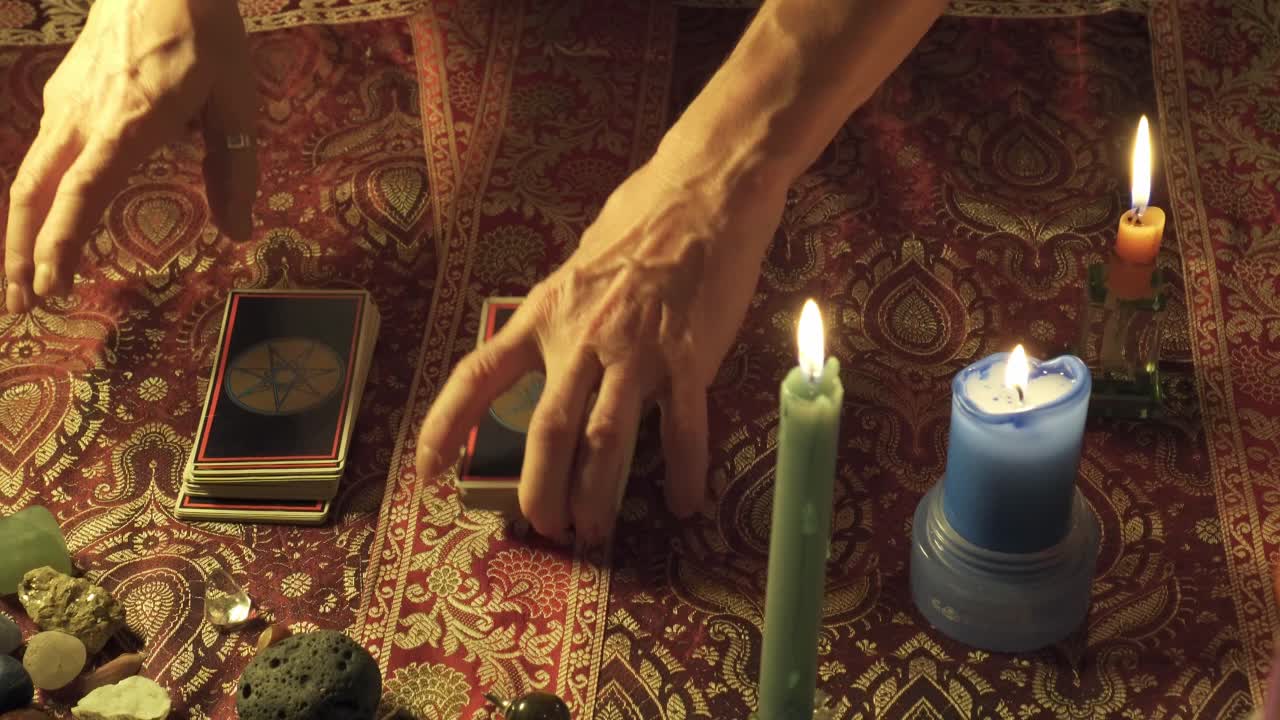 Close-up of tarot deck being shuffled and cut before reading the client's future in an real consultation of a mystic and exoteric fortune teller