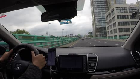 car driving through the streets of periferico sur, mexico city. time lapse