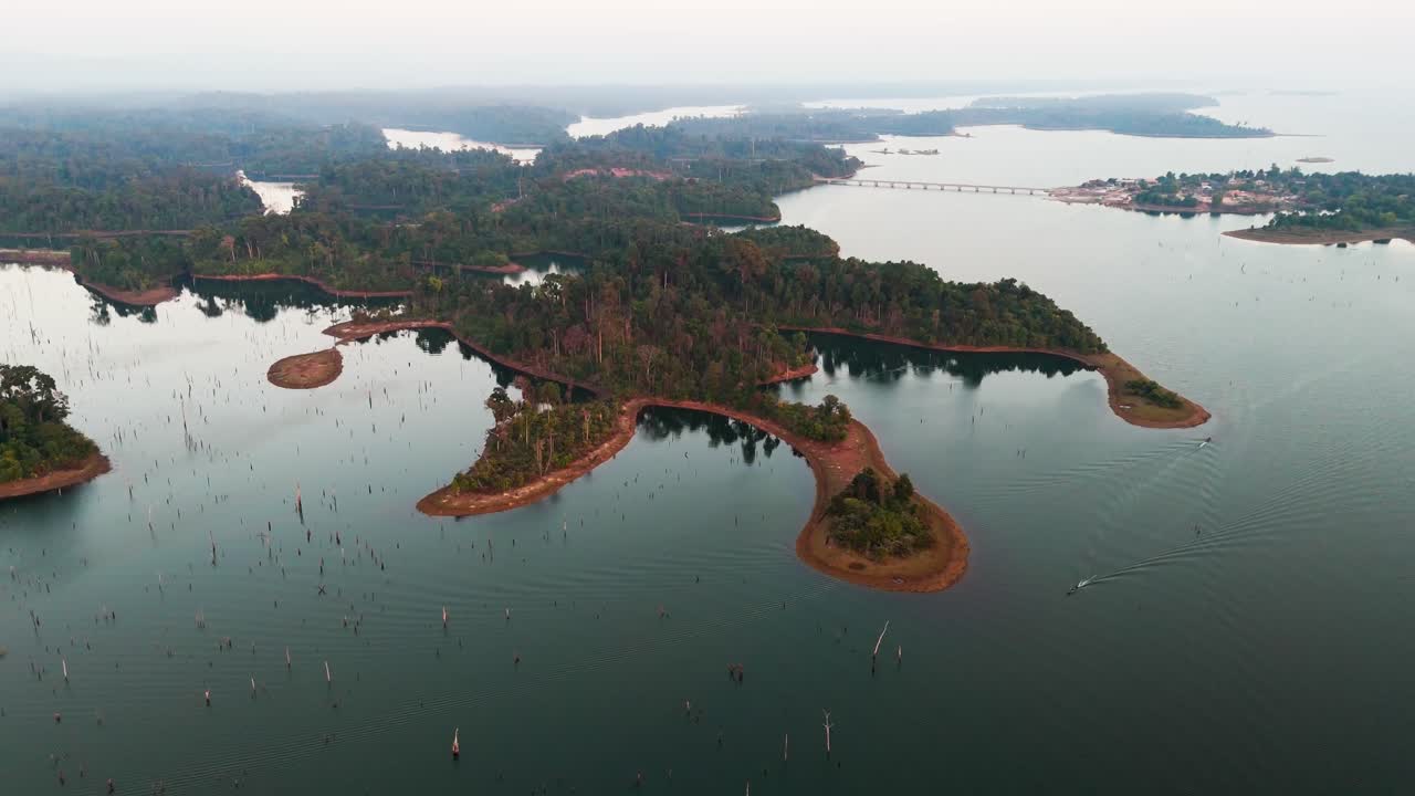 Aerial fly Laos, Thakhek Loop Landscape, Slow Boats sail at Blue lagoon water around green tropical Islands