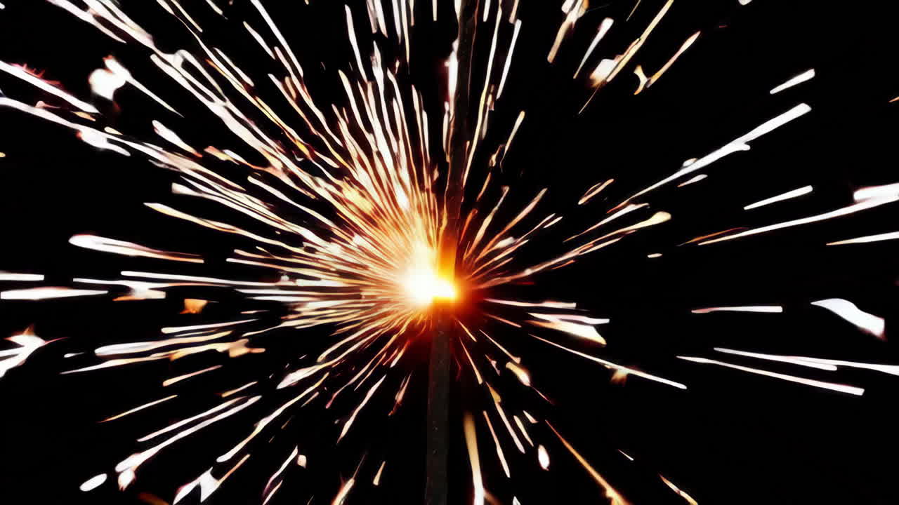 Close-up of a Sparkler Emitting Bright Sparks in the Dark
