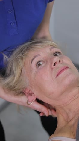 neck massage session for an elderly woman