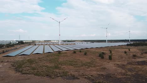 green energy farm with wind turbines and solar panels