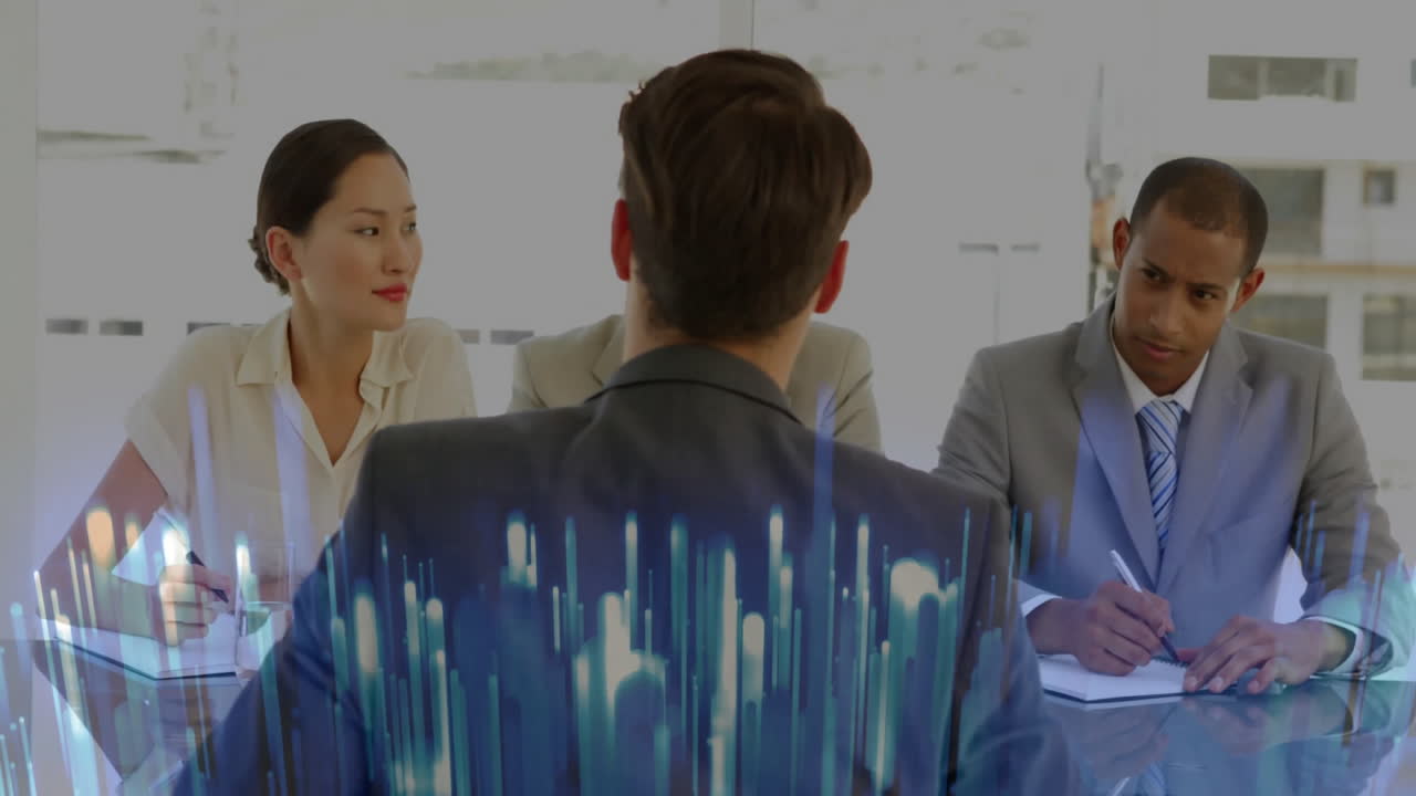 Interviewee sitting across conference table in business office, showcasing data chart overlay