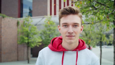 handheld view of smiling young man looking at camera