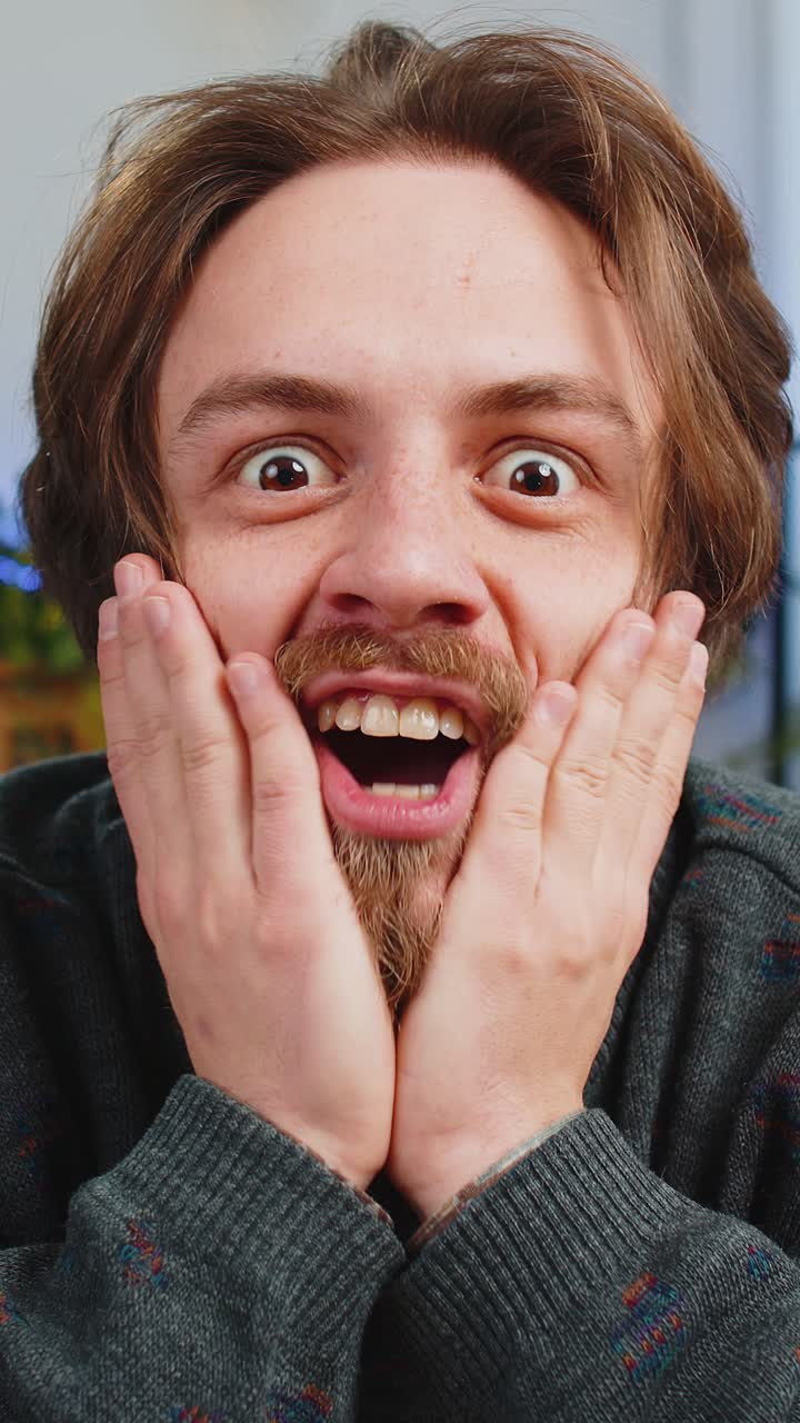 Excited caucasian man surprised shocked by sudden victory good win news celebrating wow reaction