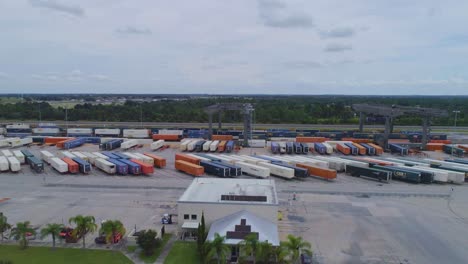 4K-Drone-Video-of-Trains-and-Trucks-at-CSX-Intermodal-Train-Yard-in-Winter-Haven,-FL