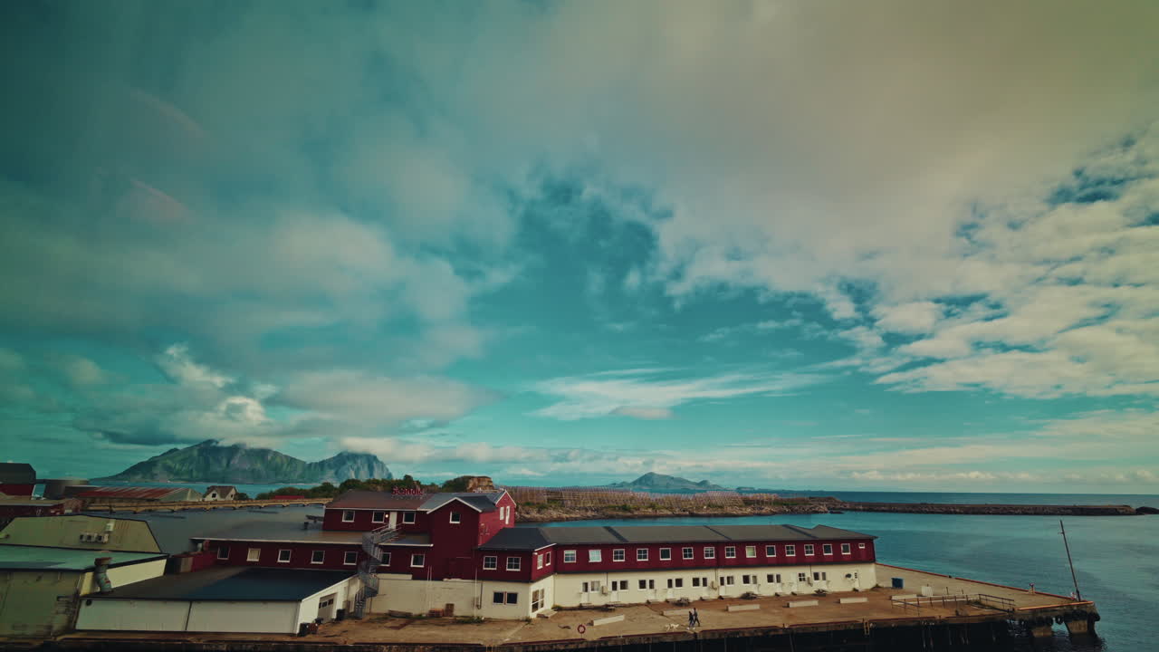 Time lapse in Svolvaer, Lofoten islands, Norway. View of the picturesque landscape, traveling clouds and red wooden buildings.