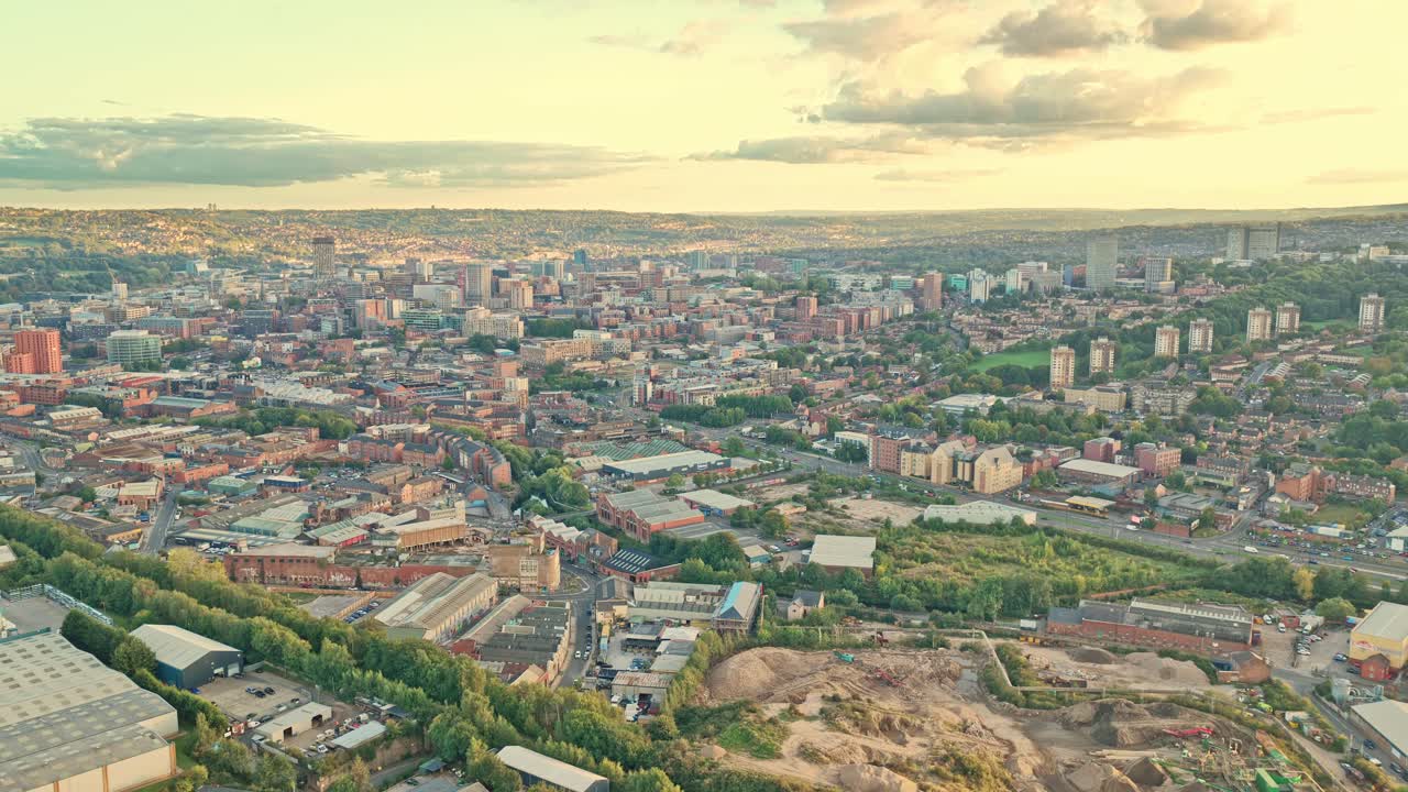 Drone establishing shot over Sheffield captures the city’s layered identity—industrial roots, modern sprawl, and green corridors—bathed in the warm glow of sunset