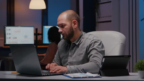 workaholic focused businessman analysing marketing graphics on clipboard