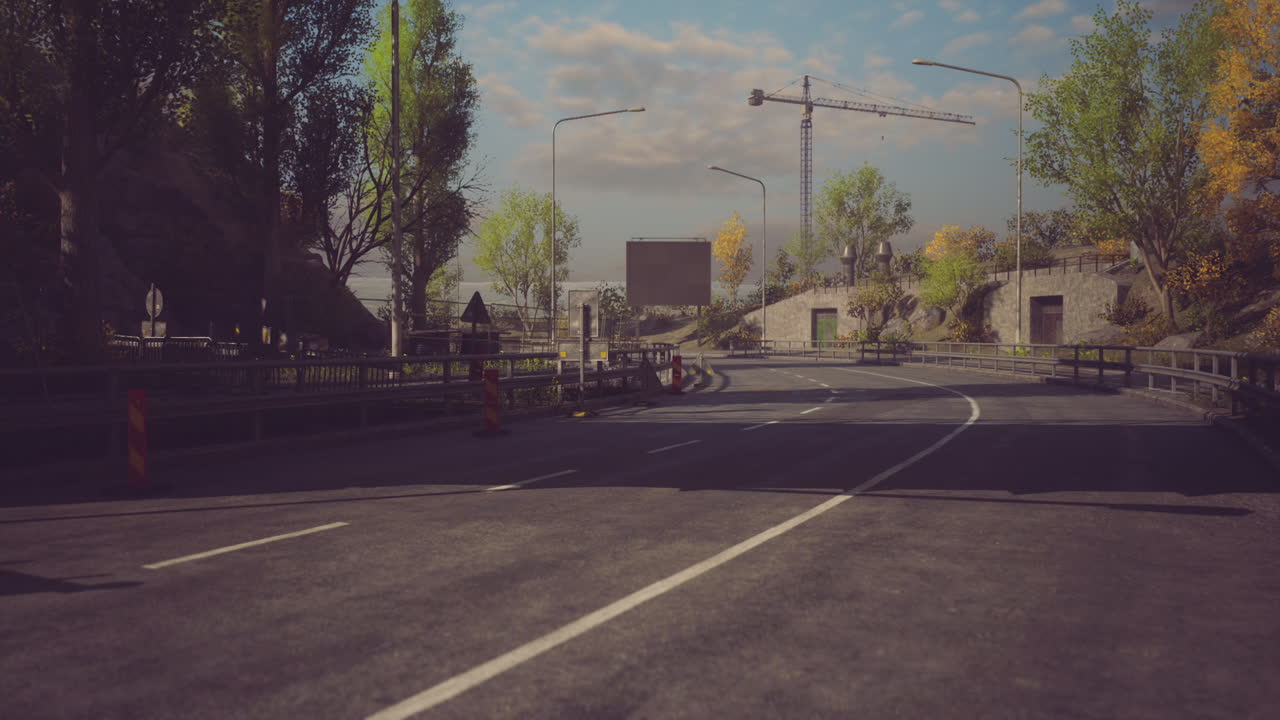 Roadway leading to construction site with clear blue sky and greenery
