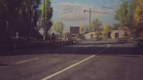Roadway leading to construction site with clear blue sky and greenery