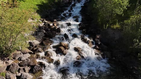 a stunning waterfall captured from a drone in the region of weesen, located on the shores of lake walensee, switzerland