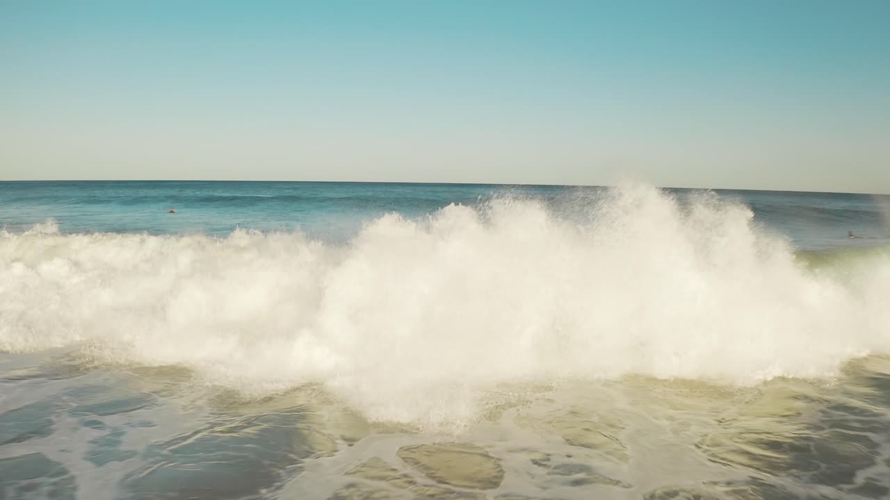 Surfer surfing big wave at sunset, aerial of barrel tube wave close up slowmo