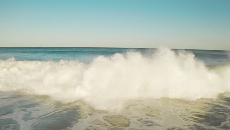 surfer surfing big wave at sunset, aerial of barrel tube wave close up slowmo