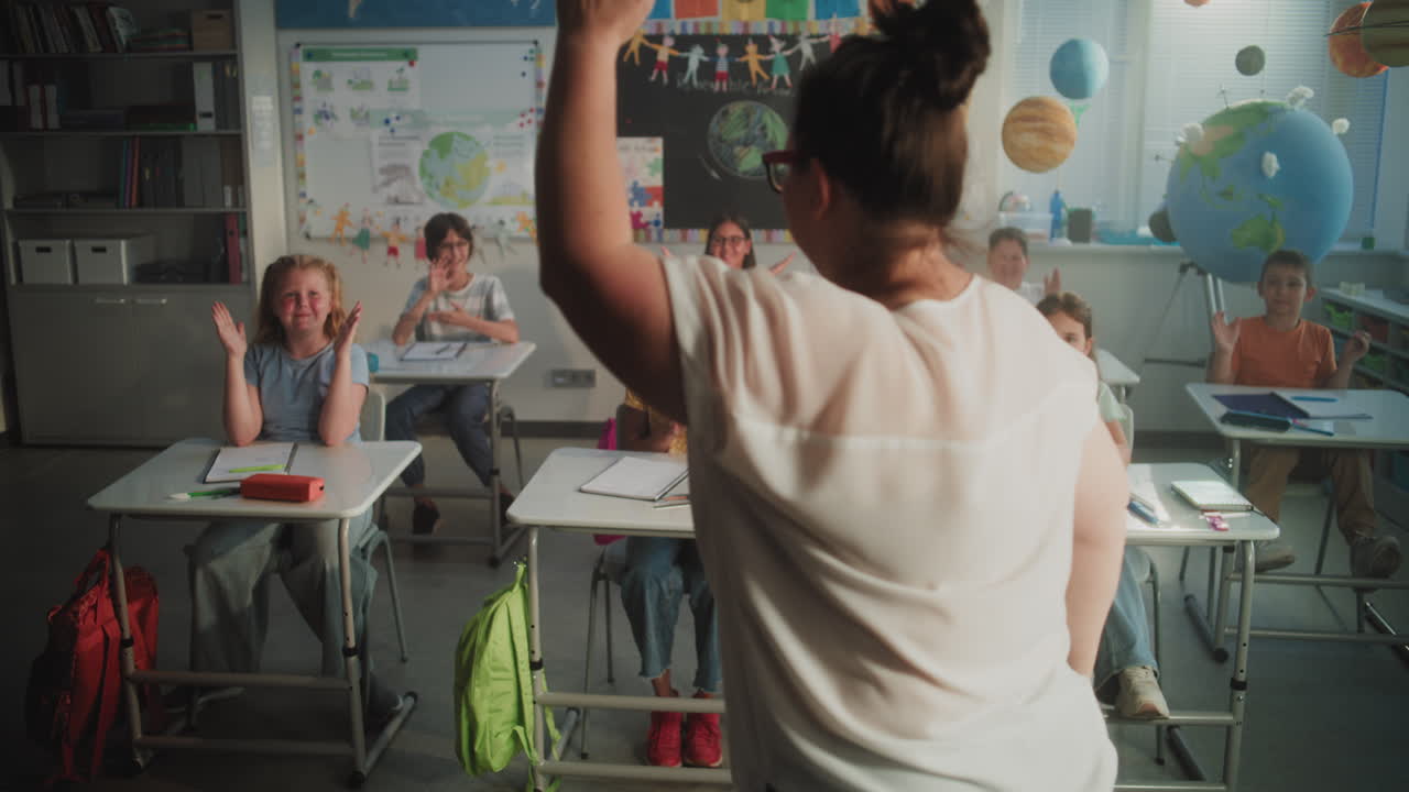 Cheerful Diverse Kids Clapping Their Hands Interacting with Teacher During Dynamic Gamified Activity