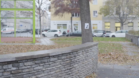 handheld shot of male doing parkour over wall in 4k