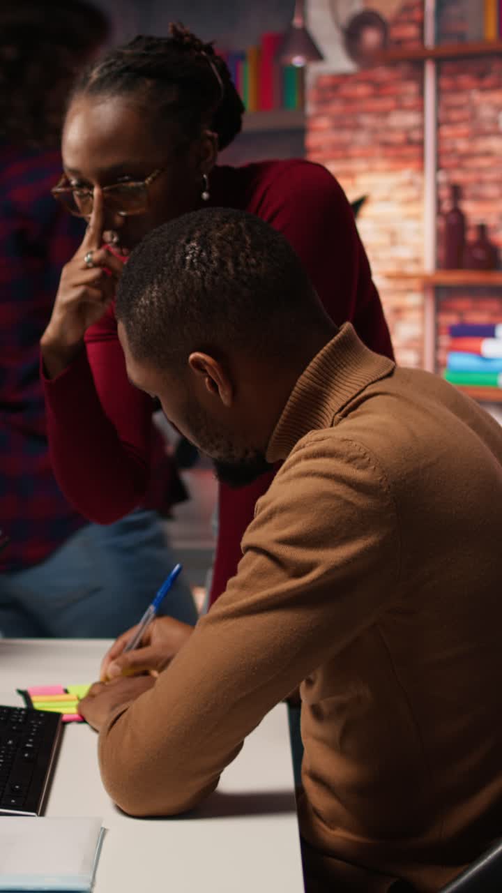 Vertical video AI tech venture employees leaving memo notes on PC to remember later