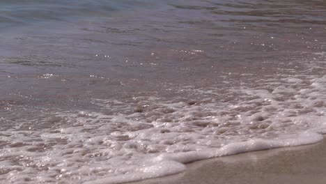 Tilt-Slowmotion-shoot-for-a-sea-wave-on-a-sand-beach-in-Cagliari,-Sardinia