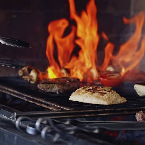 cooking food in fire. delicious meal on grid preparation by chef. vegetables on grill. bright flame during the cooking dishes.