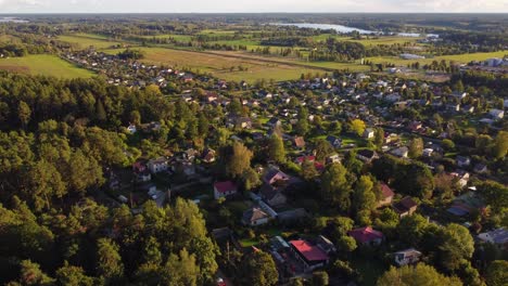 drone footage moving up over suburban landscape in ogre, latvia