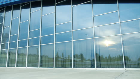 businessman in superhero outfit running outside a modern building