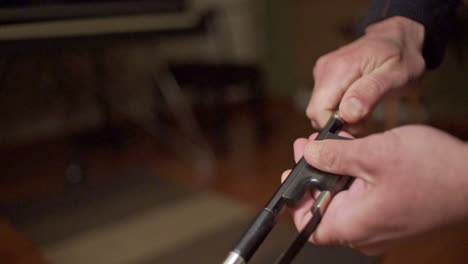 Footage Of A Musician Tune Up A Bow Of A Double Bass CLOSE UP