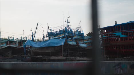 fishing boats under repair in a shipyard