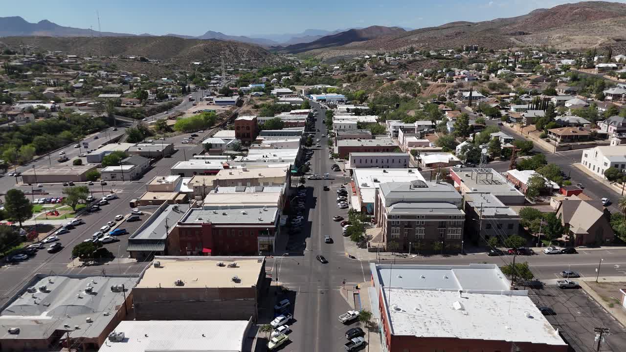 Drone Flying from South to North Broad street in Downtown Globe Arizona. Cars driving down street, mountains in background on a bright summer day