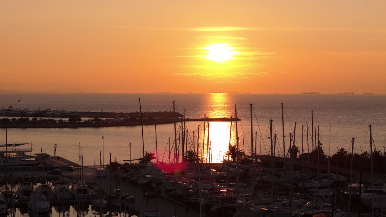 drone fly above Flisvos port Athens's center on the shores of the Aegean Sea at sunset with sails boat moored at bay