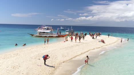 tourists at the sumilon island's sandbar in oslob, cebu, philippines. - wide shot