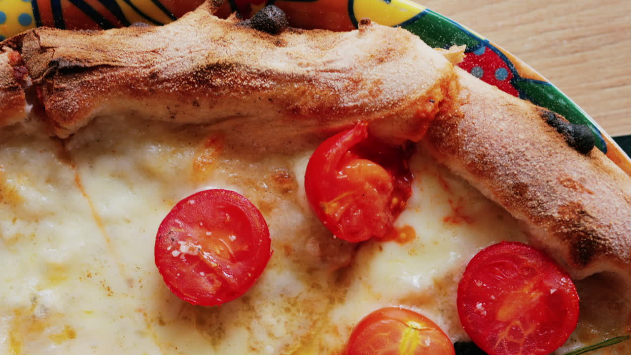 Close up of a classic margherita pizza with cherry tomatoes and basil