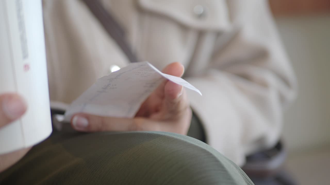 Person Reading a Receipt