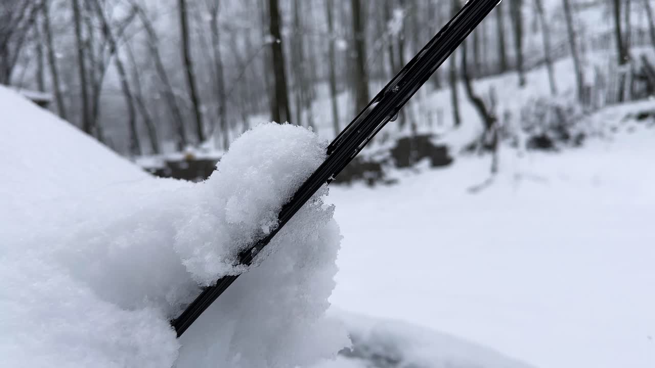Snow covered car windshield in rural village in winter season beside forest wooden house hut in Hyrcanian landscape Iran freezing nature mountain cabin heavy frost countryside scenic travel highlands