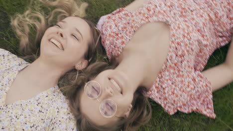 two happy friends relaxing in a park