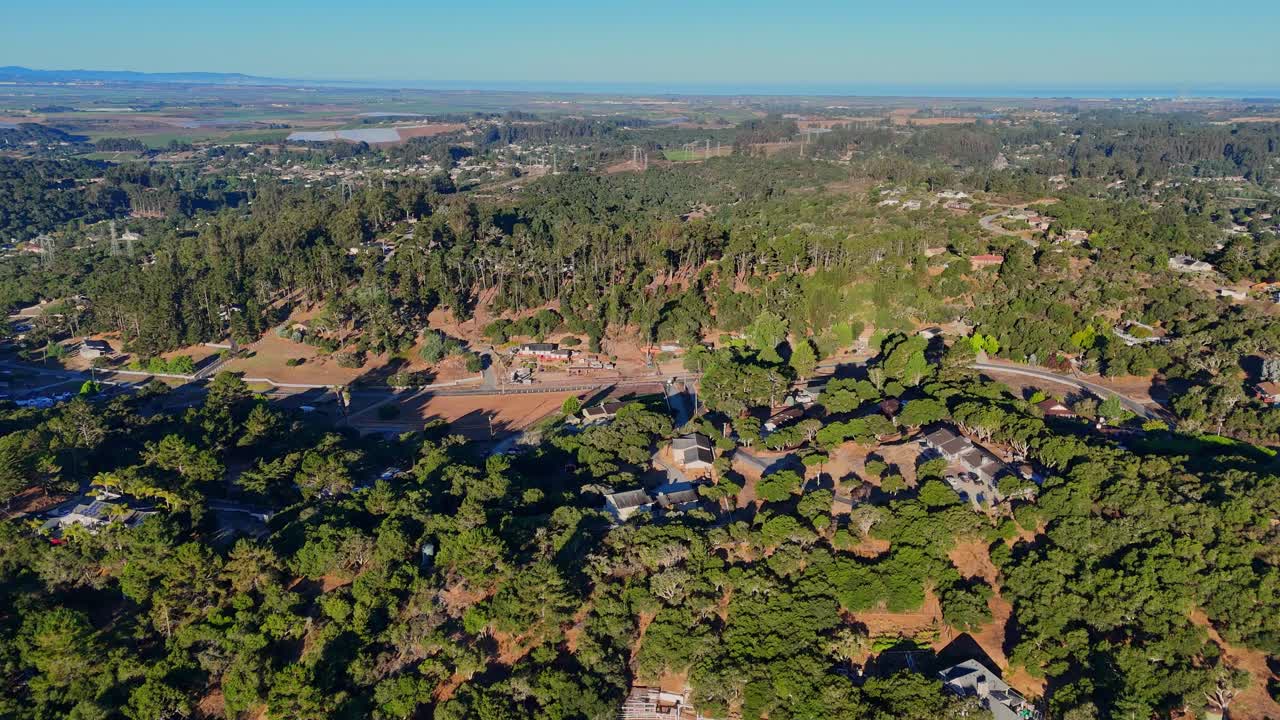 Aerial view of tree-covered hills and scattered homes near Salinas Valley, California