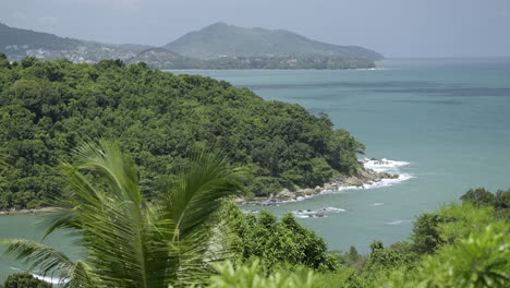 tropical coastal landscape with lush green hills and turquoise waters