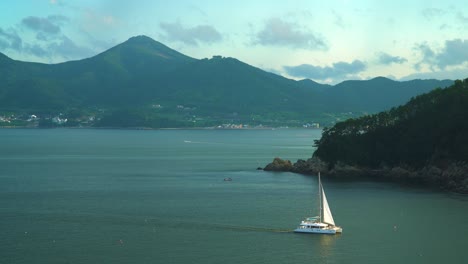 Picturesque-Scenery-Of-Geoje-Island-With-Luxury-Catamaran-Yacht-Sailing-Near-Hanwha-Resort-Geoje-Belvedere-In-South-Korea