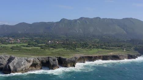 aerial establishing view of rocky chimney coastline of bufones de pria asturias spain limestone cliffs