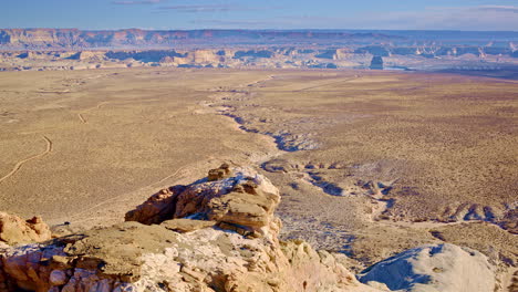 a drone soars around the mesmerizing eroded rock formations of glen canyon and lake powell near page, arizona.